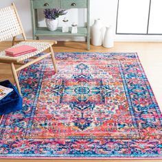 a colorful area rug with an ornate design on the center and side, next to a chair