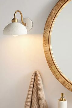 a bathroom with a round mirror on the wall