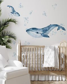 a baby's room with two whales and bubbles on the wall