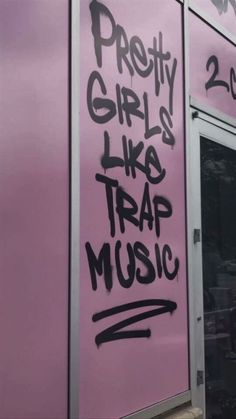 graffiti on the side of a pink building that says pretty girls like trap music written on it