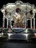 a gazebo decorated with christmas lights and a tree