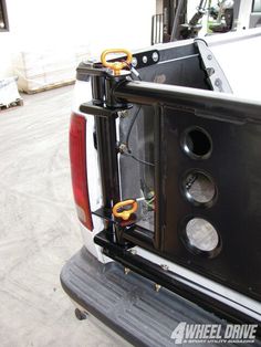 the back end of a white truck with some tools in it