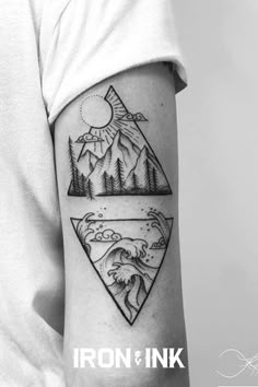 a man with a tattoo on his arm that has mountains and waves in the water