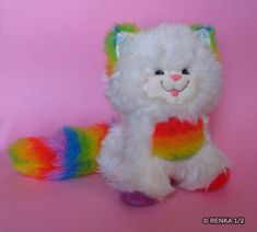 a white stuffed animal with multicolored manes