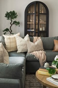 a living room filled with furniture and pillows