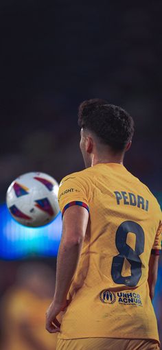 a soccer player is about to kick the ball in mid air with his right hand