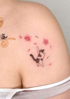 a woman's stomach with a tattoo on the side of her body and flowers in the background