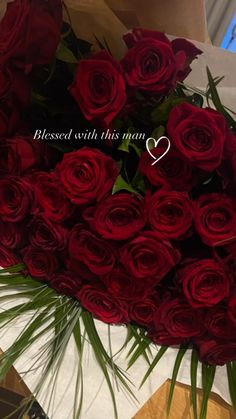 a bouquet of red roses with a message written on it