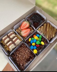 a box filled with lots of different types of desserts and candies on top of each other