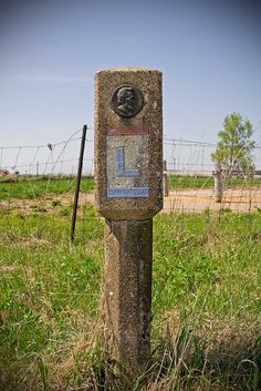 an old parking meter sitting in the middle of a field