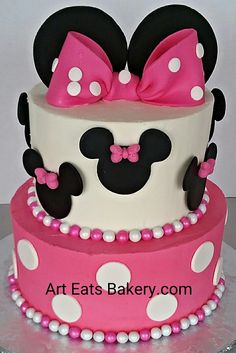 a minnie mouse cake with pink and white polka dots