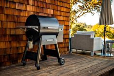 a bbq grill sitting on top of a wooden deck