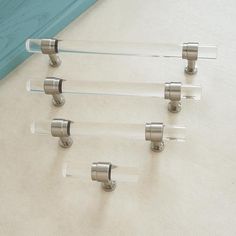 four glass holders with metal handles on a table