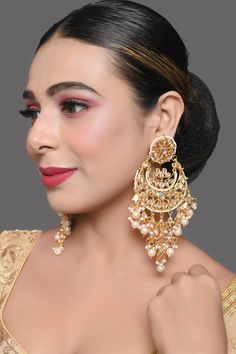 Super versatile kundan embellished pearl beaded Chandbali earrings , one of our absolute bestsellers! composition : Metal copper alloy, Synthetic Pearls,  Work : kundan with meenkari on back side  measurement  Length - 5.2in, Width - 1.6in closure- push back Care Instruction  Spot-Cleaning only. Store in a  pouch& box. Keep away from fragrance and water.