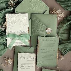 the wedding stationery was done in green and white