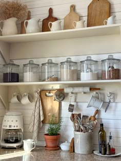 the shelves are filled with pots, pans and utensils on top of them