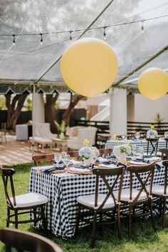 a table set up for a party with blue and white checkered cloth on it