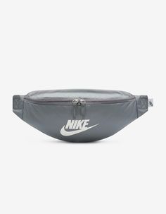 Nike Heritage Waist Pack. A Comfortable And Easy To Adjust Strap Makes The Nike Heritage Waist Pack A No Brainer For Everyday Trips. The Main Compartment Provides Secure Storage For Your Phone, Snacks Or Wallet While The Smaller Accessories Pocket On The Backside Helps Keep Things Like Your Keys, Travel Info Safe And Close At Hand. The Buckle Snaps Together In The Middle Of The Strap For A Comfortable, Easy-To-Adjust Fit. The Bag Can Be Worn At Your Waist, Across Your Body Or Over Your Shoulder. Dual-Zipper On The Front Pocket Provides Easy Access To Larger Items. Dual-Zipper On The Back Keeps Smaller Items Stored Securely. 16"l X 4"w X 6"h. Volume: 3 L. 100% Nylon. Spot Clean. Imported. Nike Belt Bag, Hip Pack, Pack Bag, Trendy Shoulder Bag, Adjustable Bag, Silver Lights, Travel Info, Waist Pack, Small Accessories