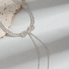 ✦ Make a dazzling entrance with our Exquisite Sparkly Rhinestones Ribbon Choker. This necklace is designed to turn heads and elevate your look. The rhinestones are intricately arranged in a ribbon pattern, reflecting light and creating a sparkling effect. The adjustable ribbon closure ensures a perfect fit, and the tassel detail adds a touch of movement and charm. Whether worn for a special occasion or to add a touch of glamour to your everyday style, this sparkly choker necklace is a must-have Silver Sparkling Rhinestone Necklace, Adjustable Silver Sparkling Rhinestone Necklace, Silver Rhinestone Choker With Adjustable Chain, Party-style Long Rhinestone Necklace With Adjustable Chain, Metal Rhinestone Choker Necklace, Ribbon Choker, Special Occasion, Everyday Fashion, Choker Necklace