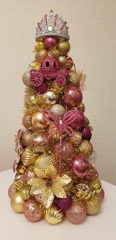 a christmas tree with ornaments and a crown on top