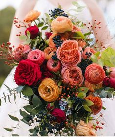 a bride holding a bouquet of flowers in her hands