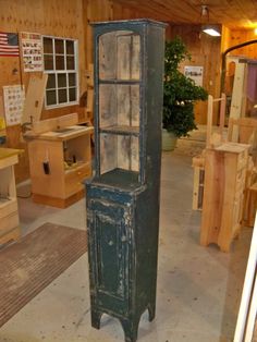 an old wooden cabinet sitting inside of a shop