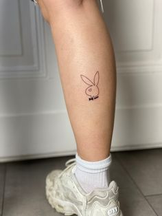 a person with a bunny ear tattoo on their leg