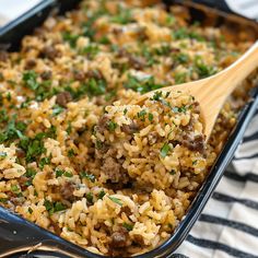 a casserole dish filled with rice and meat, garnished with parsley