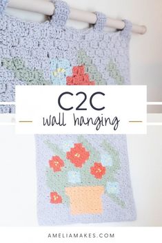 a crocheted bag hanging on a clothes line with the words c2c wall hanging above it