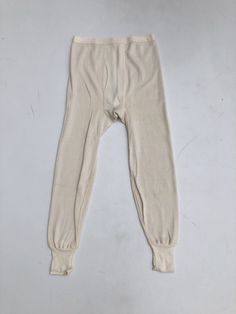 "1970s cotton thermal long Johns have elastic around the waist, knit rib at the hems, and flat piping around the crotch area. Made in USA. 100% cotton. Condition Excellent. Measurements Waist 30\"-40\" Hip 36\"-42\" Rise 16\" Inseam 26\" Length 40\" Tag size is a large 38-40." Fitted Ribbed Cream Bottoms, Stretch Cotton Ribbed Pants, Solid Cotton Ribbed Pants, Ribbed Cotton Pants, Solid Color Cotton Ribbed Pants, Winter Cream Ribbed Bottoms, Ribbed Cotton Long Pants, Ribbed Cotton Pants For Winter, Winter Cotton Ribbed Pants