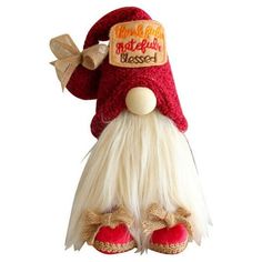 a red and white gnome hat on top of a stuffed animal