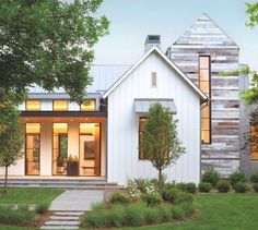 a white house with lots of windows and grass