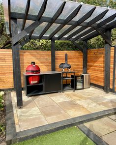 an outdoor bbq with grill and barbecue table