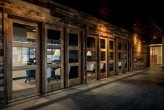 an empty room with wood paneling and glass doors