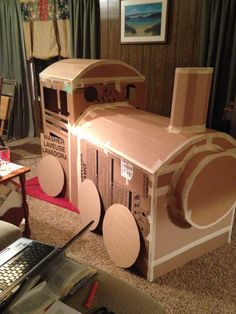 a cardboard train that is sitting on the floor