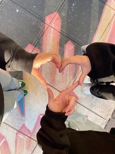 two people making a heart with their hands