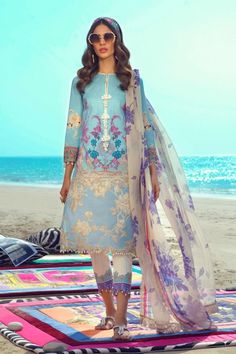 Sana Safinaz Eid Collection Lawn Dress emblazoned with beautiful print and embroidered organza patch. Sana Safinaz Summer Collection is very stylish and you can wear these dresses on Party or Eid Events. Buy Online Sana safinaz new collection at this store and change your look. Shirt: Pretty Shirt in light blue color is embellished with digital printed front and back on lawn fabric. Sleeves are also printed. Shirt daman is also embellished with organza patch. Trouser: Beautiful dyed trouser in m Sana Safinaz Lawn Collection 2020, Pakistani Designer Suits, Pakistani Lawn Suits, Summer Lawn, Lawn Dress, Sana Safinaz, Pretty Shirts, Lawn Fabric, Lawn Suits