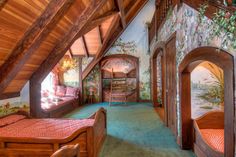 an attic bedroom with two beds and a ladder to the ceiling, painted mural on the walls