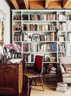 a room filled with lots of books and furniture