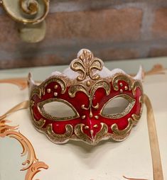 Original Venetian mask handmade in carâché and hand painted in acrylic colors and gold/silver leaf.Beautiful to wear on some particular occasion but also as a decoration of the house.All our masks are handmade by our staff (me, my wife and our collaborators) in our atelier in Venice. The masks are all made of paperweight and are made using ancient techniques from the 1300sThey are decorated with acrylic colors, gold leaf, silver leaf, trifies, lace and Swarovski crystals so as to make them more Artistic Red Masks For Costume Party, Artistic Red Mask For Costume Party, Artistic Red Masquerade Mask For Mardi Gras, White Venetian Masquerade Mask As Gift, White Venetian Masquerade Mask For Gift, Red Masquerade Mask For Carnival Festivals, Red Carnaval Festival Masquerade Mask, Venetian Masks For Mardi Gras, Venetian Masks For Mardi Gras Gift