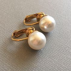 These Classic Pearl Clip on Earrings are so elegant on! I make these using 10mm Swarovski Pearls in your choice of either Cream Ivory or White pearls with finishes in Gold or Silver tone clip settings. Available in some other color choices...just ask! Choose the color and finish from the Drop-down menu. Perfect Bridal Wedding jewelry with clip on backs. These are also available in Pierced styles and quantities for Bridesmaids! These photos show: Silver with Cream Ivory pearls and Gold with White Elegant White Earrings With Screw Back, Classic Clip-on Earrings For Wedding, Classic Wedding Clip-on Earrings, Classic Clip-on Pearl Drop Earrings, Classic Round Clip-on Earrings With Pearl Drop, Classic Round Pearl Drop Clip-on Earrings, Formal White Pearl Drop Clip-on Earrings, Classic White Clip-on Pearl Earrings, White Round Clip-on Earrings For Wedding