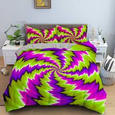 a bed with purple and green designs on it