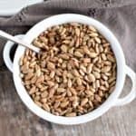 a white bowl filled with oats on top of a wooden table