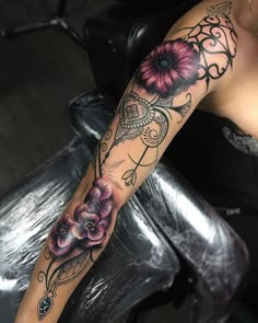 a woman's arm with flowers on it