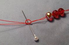 a red string with three beads attached to it