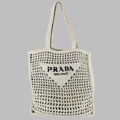 Prada Handbag In A Mint Green Raffia Featuring A Crochet Woven Design With Black Prada Logo, And Tote Bag Style. Made In Italy.Very Good Pre-Owned Condition. Measurements: Length: 14 Inches Width: 1.25 Inches Height: 14 Inches Drop: 10 Inches Sui Generis Reference: 133050 Category: Handbag & Leather Goods More Details Brand: Prada Color: Green Color 2: Mint Pattern: Crochet Material: Raffia Style Bag: Tote Age Group: Adult Made In: Italy Sui Generis Designer Consignment Is An Award Winning Fashi Beige Crochet Bag With Intrecciato Weave For Shopping, Designer Beige Crochet Bag For Travel, Designer Natural Rectangular Crochet Bag, Designer Rectangular Natural Crochet Bag, Designer Natural Color Rectangular Crochet Bag, Designer Beige Crochet Shopping Bag, Chic Crochet Bag With Intrecciato Weave For Shopping, Designer Rectangular Crochet Bag For Beach, Designer Crochet Rectangular Bag For Beach