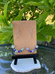 These beads look stunning in both natural and artificial lighting. The hoops are dainty and lightweight so you can wear them all day!! This pair features round gray beads with a variety of blue Czech glass beads. The wire is silver as well as the ear wire. All metals used are nickel free and each item is handmade!  Show me how you wear them on Instagram @CJasmine'sArt ! Unique Blue Hoop Earrings With Ear Wire, Blue Wire Wrapped Small Hoop Earrings, Handmade Minimalist Blue Hoop Earrings, Blue Wire-wrapped Round Earrings, Blue Wire-wrapped Dangle Hoop Earrings, Grey Beads, Ear Wire, Jewelry Earrings Hoops, Czech Glass Beads