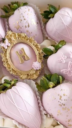 a box filled with pink and gold chocolate covered strawberries