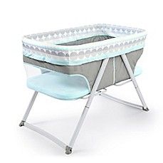 a baby crib that is sitting on top of a white floor with blue trim