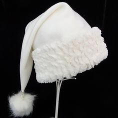 "Novelty Santa hat is made up in a creamy and cozy winter white poly fleece fabric. Hat is styled in the classic Santa slouch cone and is accented with a soft matching faux fur fabric trim with a faux fur pompom on the top. Proportions of the hat are generous and will fit most head sizes, ladies or gents. Measurement for opening for your head is 24-25\" circumference and the length is 20\". Check measurements to make sure this size will work for you. Custom orders depend on fabric availability a Adjustable White Felt Hat For Winter, White Brimmed Felt Hat For Winter, White Mini Hats For Winter Party, White Beanie Costume Hat For Winter, White Winter Hat, One Size Fits Most, Adjustable Cream Winter Felt Hat, White Winter Beanie Costume Hat, White Beanie For Winter Costume, White Beanie For Winter Festival